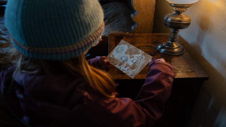 Child looking at a sketch in the East Bedroom, Lindisfarne Castle.